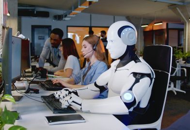 Robot,Working,At,Computer,Among,People.,Maschine,Typing,On,Keyboard
